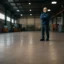 Empty industrial warehouse with man
