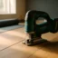 Cordless jigsaw cutting wooden floor